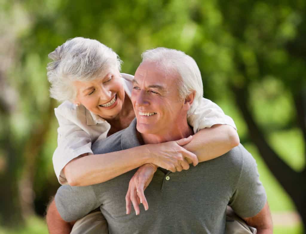 Confident husband carrying wife